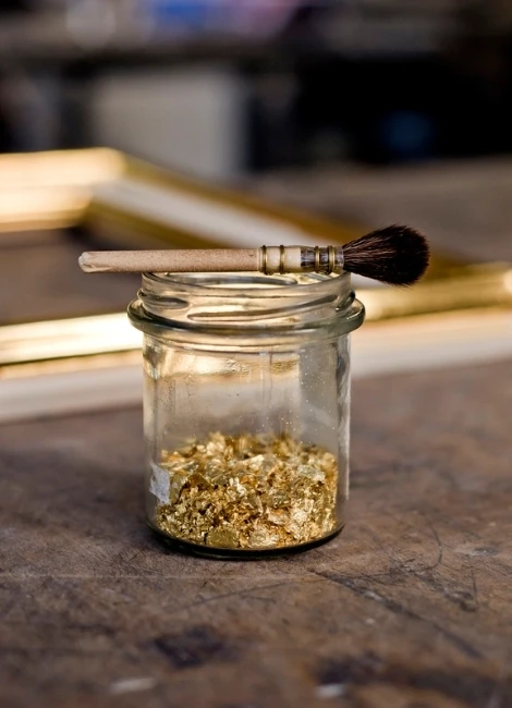 Employer Brand Fotografie in München - Detailaufnahme mit Pinsel und Blattgold in kreativer Arbeitsumgebung