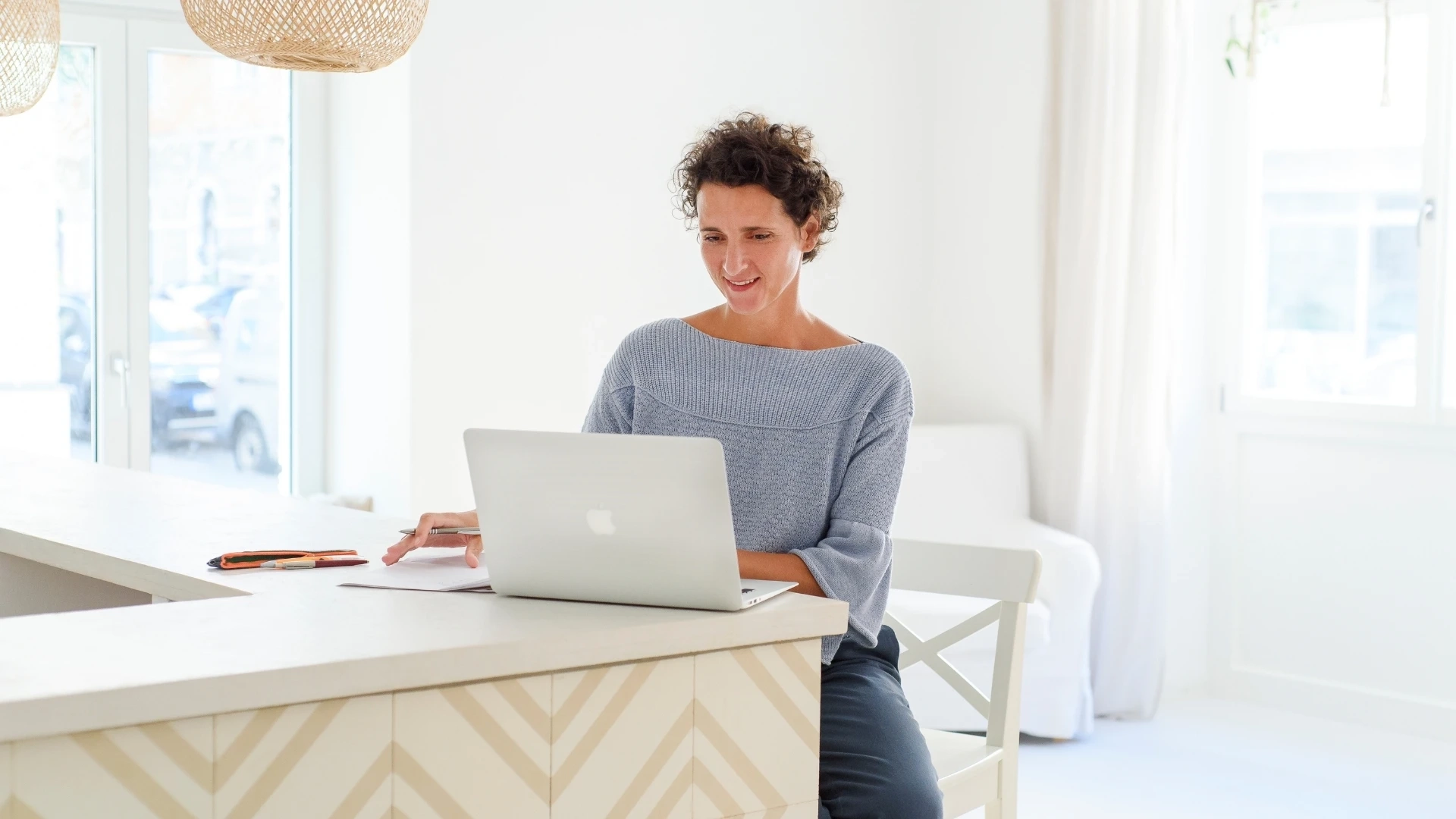 Personal Brand Fotografie in München - Unternehmerin arbeitet konzentriert am Laptop in heller Arbeitsumgebung